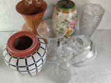 many different vases and glasses on the table