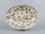 an image of a green and white plate with a design on it