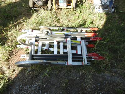 a pile of skis and ski poles on the ground