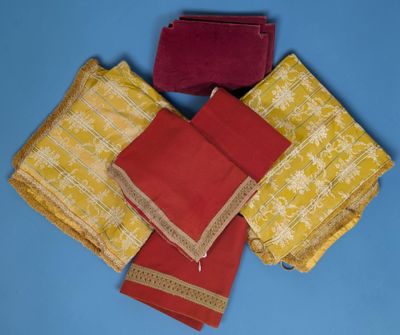 four pieces of red and yellow cloth on a blue surface