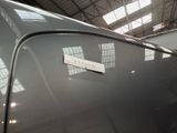 a sticker on the hood of a car in a garage