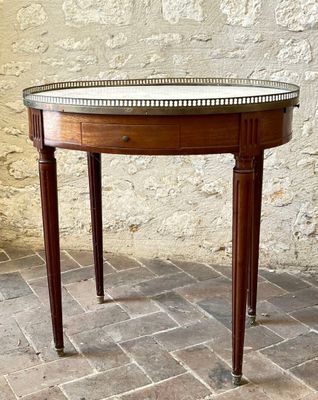 a small table with a glass top on a brick floor