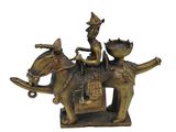 brass figurine of a man riding a horse with two dogs