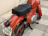 a red motorcycle parked on the side of the street
