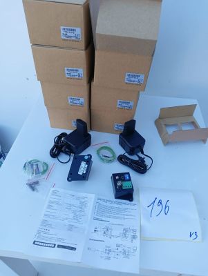 several boxes of electronic equipment sitting on top of a white table
