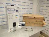 a box with a remote control and other items on a table