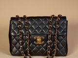 a black chanel bag with a gold chain strap