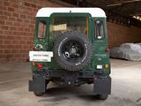 an image of a green land rover parked in a garage