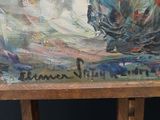 a painting that is on a easel in front of a painting