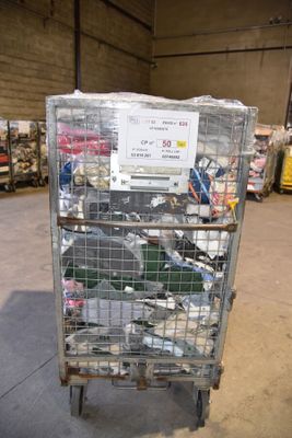 a metal cart with many items in it in a warehouse