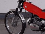 a red motorcycle that is parked in a garage