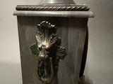 a silver clock with a face on the front of it