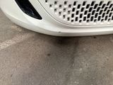a white car that is parked in a lot