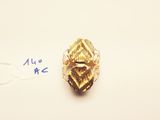 a close up of a gold ring on a white surface with a price tag