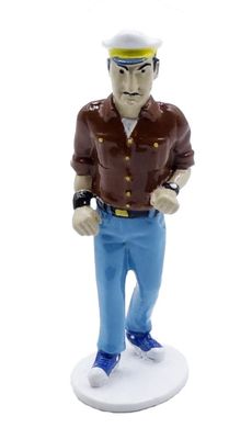 figurine of a man in a brown shirt and blue pants