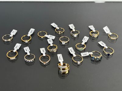 several different types of rings with name tags on them sitting on a table