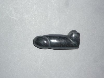 a small black object on a table with a white background