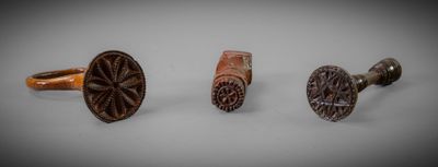three different types of wood and metal cufflinks on a white surface