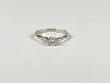a white gold ring with a single diamond