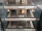 a glass display case with a lot of food inside of it