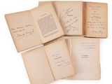 several open books with handwriting on them sitting on a white surface