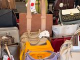 a lot of purses on a table in a store