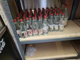 many bottles of soda sitting on a shelf in a store