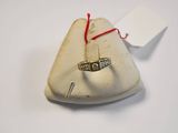 a ring on top of a small bag with a red string