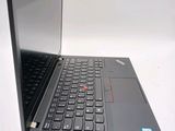 a black laptop with a red button on the keyboard