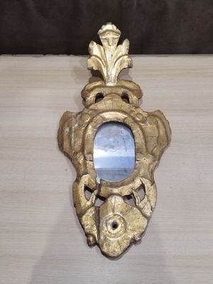 a mirror on the wall in the shape of a fish