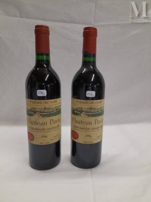 two bottles of red wine sitting next to each other on a table