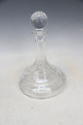 a glass candle holder on a table with a white table cloth