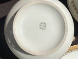 many plates and bowls that are sitting on a table