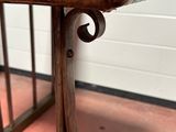 a close up of a wooden bench with a leather seat