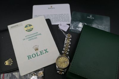 a watch and a wallet sitting on a table