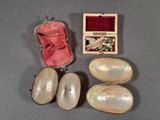 a box of pearls and a pair of earrings on a table