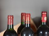 several bottles of wine are lined up in a row on a table
