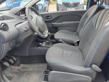 the interior of a small car with two seats and a steering wheel