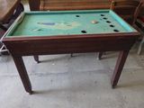 a pool table that is sitting in the middle of a room