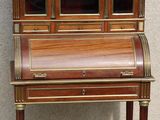 an old wooden desk with a glass front door and drawers