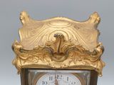 a gold clock that is sitting on top of a table