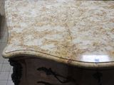 a marble table with a drawer underneath it in a room