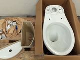 a box with a toilet and a toilet bowl in it