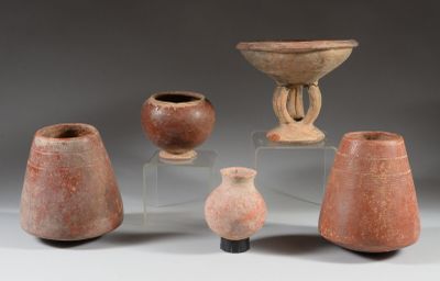 several pieces of pottery sitting on top of a table next to each other