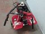 a small red machine that is sitting on the floor