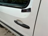 a white car with a black handle and a black door handle