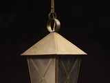 an old brass lantern hanging from the ceiling in a dark room