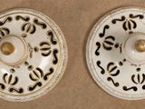 pair of porcelain plates with black and white designs on them