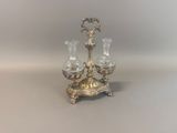a silver candle holder with three candles on it