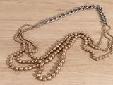 a necklace that is sitting on a wooden table